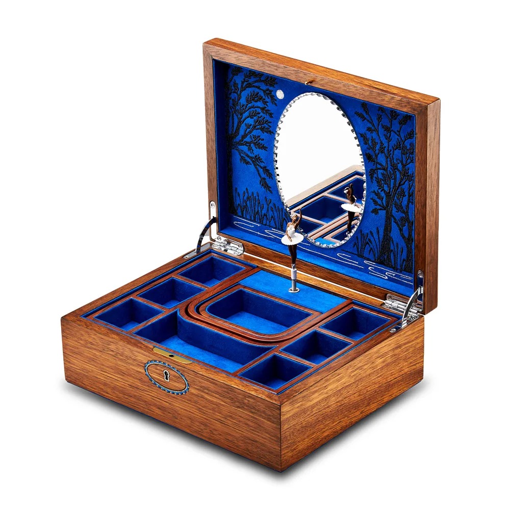 An open musical jewellery box in walnut wood, lined with blue velvet